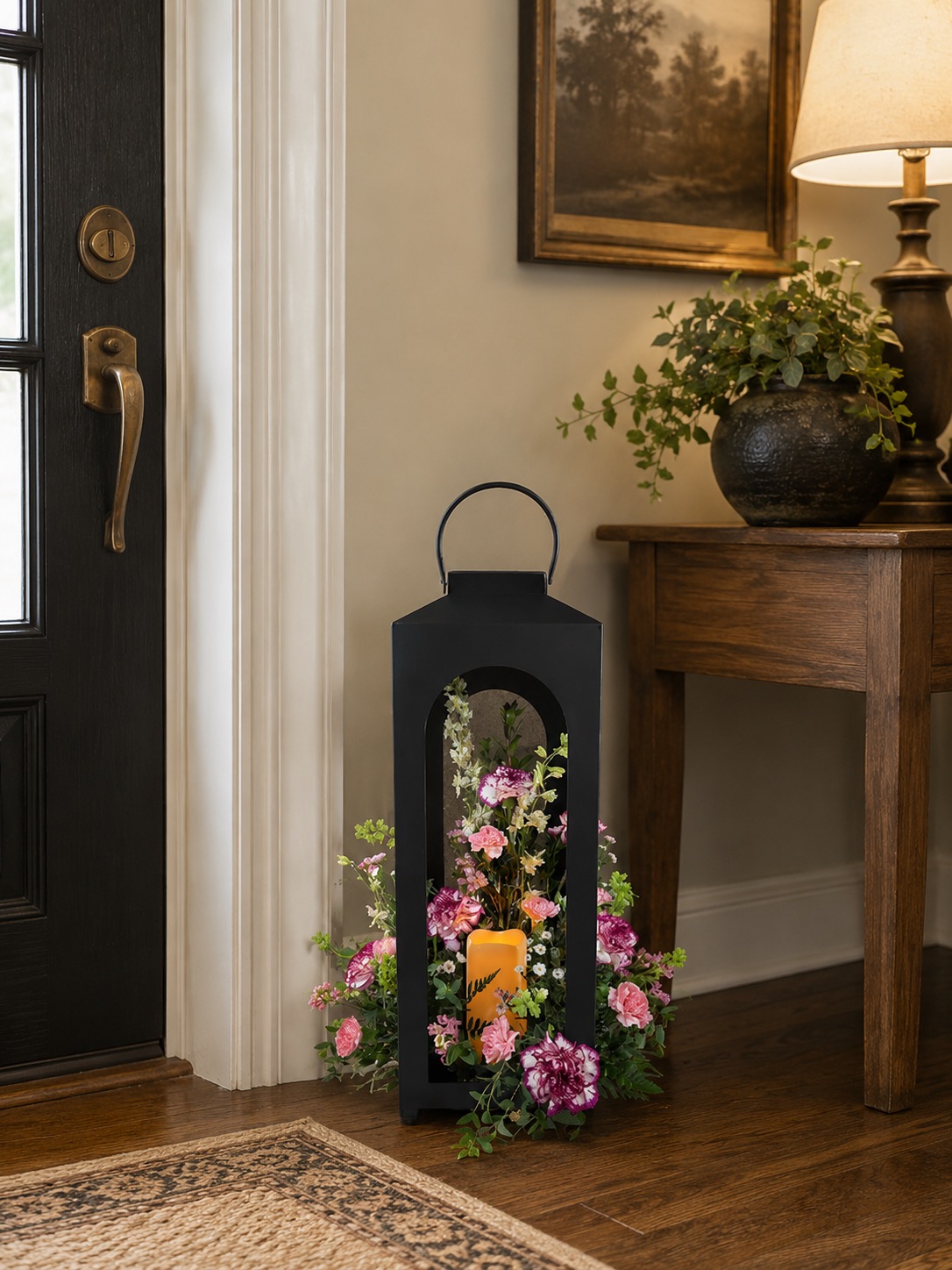 Memorial lantern with pink floral accents near an entryway