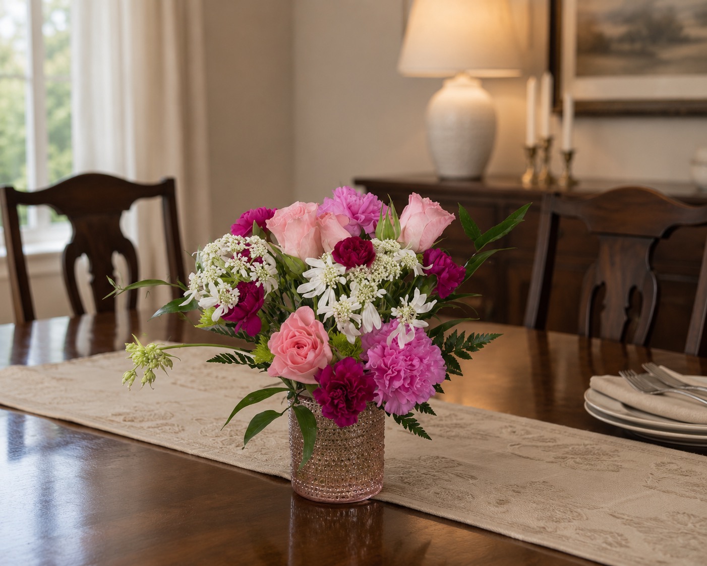 Pink flower arrangement on a dining room table